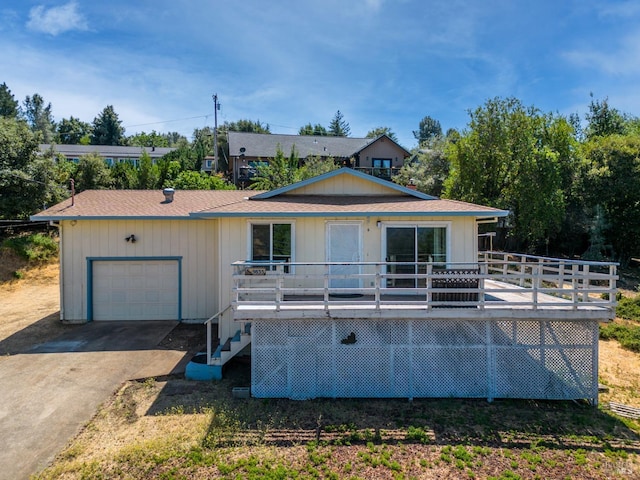 view of front of home with a deck and a garage