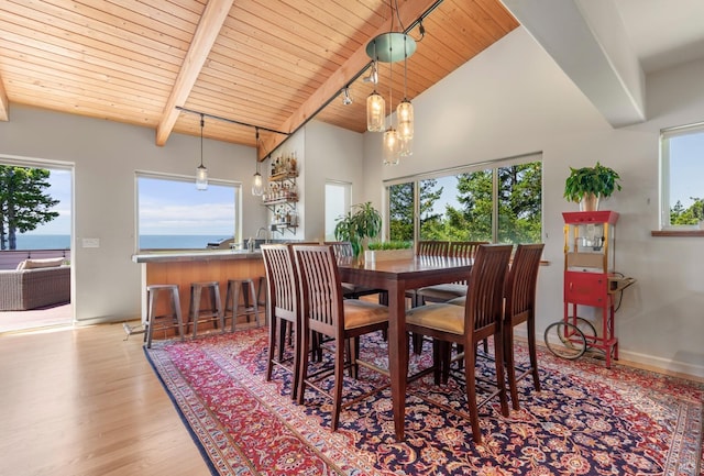dining space with baseboards, beam ceiling, high vaulted ceiling, wooden ceiling, and wood finished floors