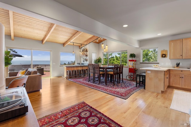 dining room featuring wooden ceiling, light hardwood / wood-style flooring, vaulted ceiling with beams, and an inviting chandelier