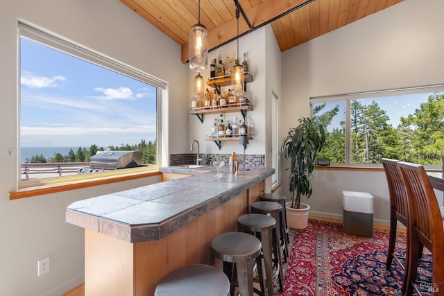 bar with wood ceiling, sink, and pendant lighting