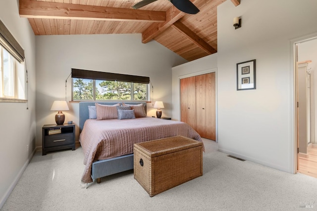 carpeted bedroom with beam ceiling, ceiling fan, wood ceiling, and a closet