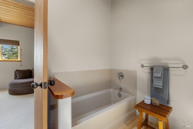 bathroom featuring a bathtub and wood ceiling