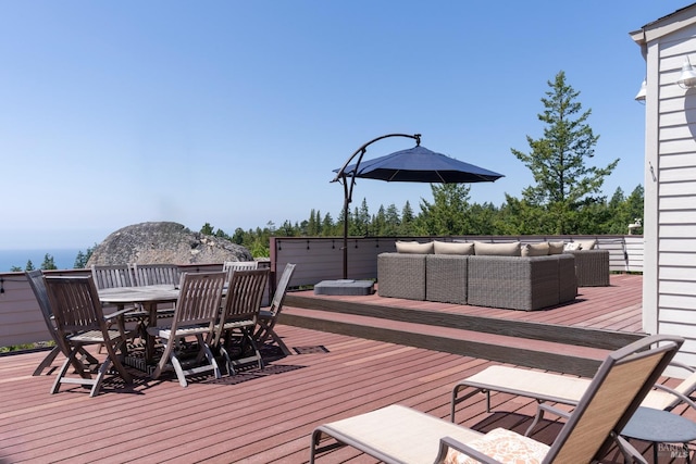 deck with an outdoor living space and outdoor dining area