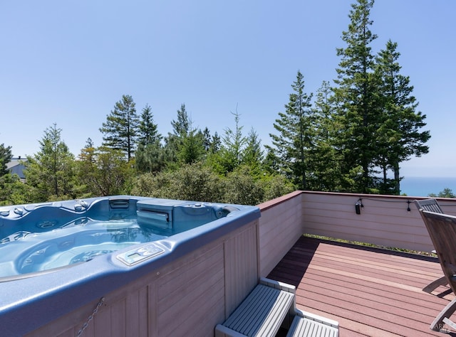 wooden deck featuring a hot tub