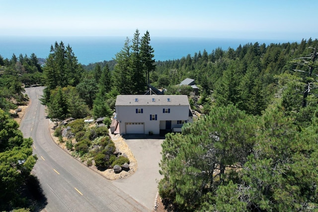 birds eye view of property with a forest view