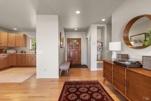 entrance foyer featuring light wood-style floors, baseboards, and recessed lighting