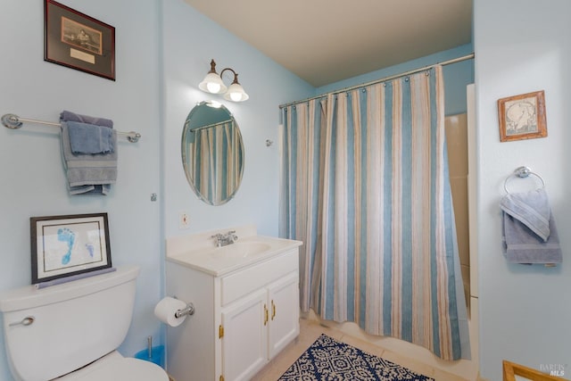 full bathroom with tile patterned floors, shower / tub combo with curtain, vanity, and toilet