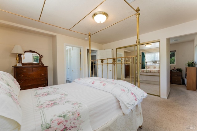 bedroom with carpet floors and ensuite bath