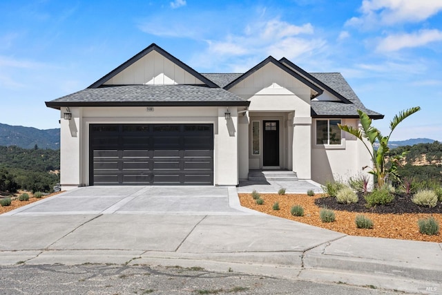 modern farmhouse style home featuring a garage, concrete driveway, and roof with shingles