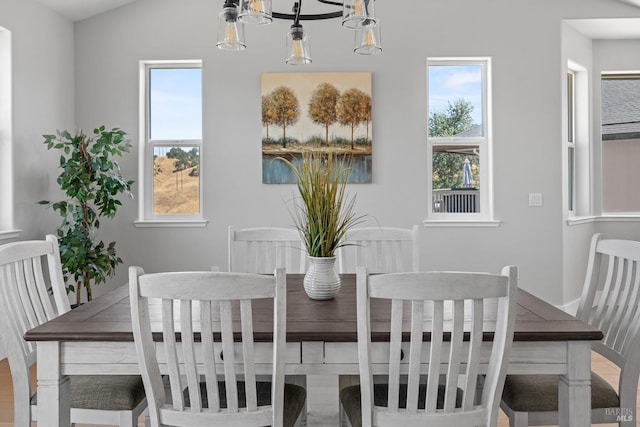 dining space with plenty of natural light and lofted ceiling