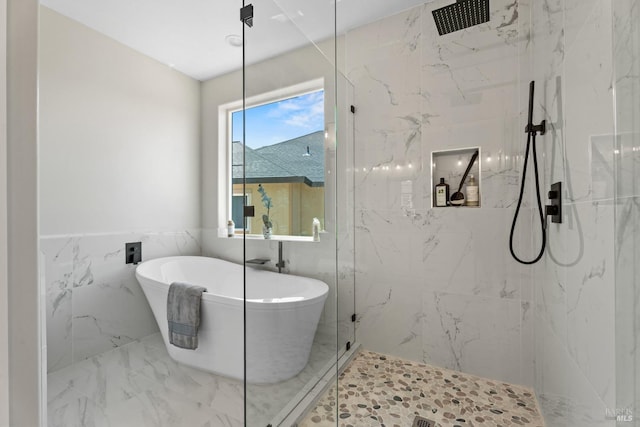 bathroom featuring separate shower and tub and tile walls