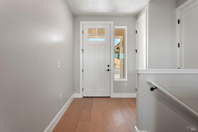 doorway featuring a wealth of natural light and light hardwood / wood-style flooring