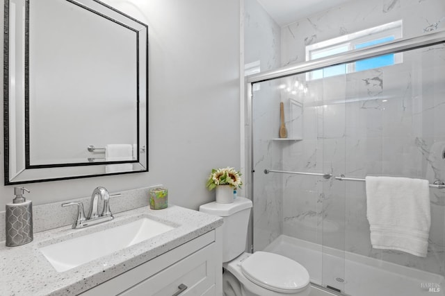 bathroom with vanity, toilet, and walk in shower