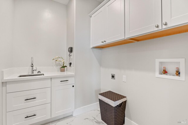 clothes washing area with cabinets, hookup for a washing machine, electric dryer hookup, and sink