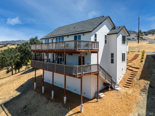 back of house featuring a wooden deck