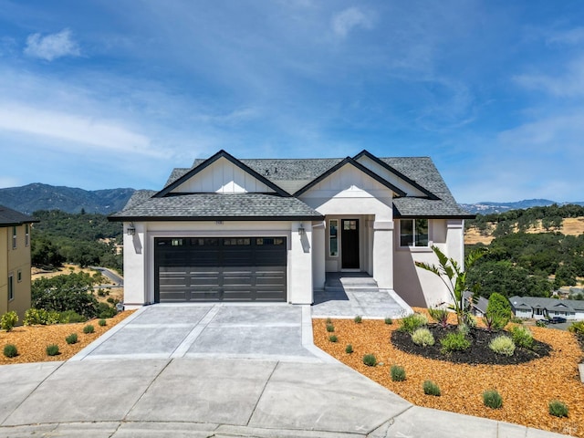 view of front facade with a mountain view and a garage