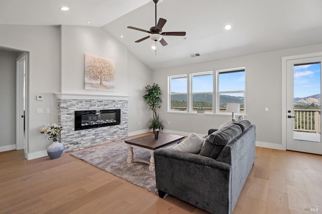 living room with a mountain view, plenty of natural light, and light hardwood / wood-style floors