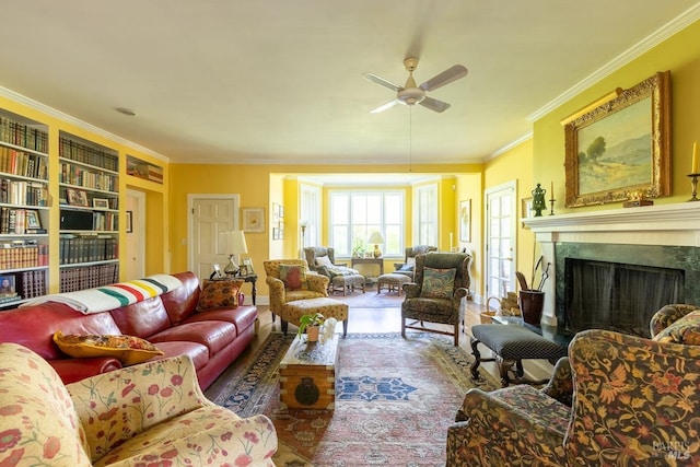 living room with a premium fireplace, ornamental molding, hardwood / wood-style floors, and ceiling fan