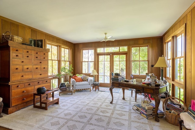 office space with wood walls and ceiling fan