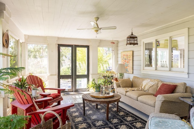 sunroom / solarium featuring wood ceiling and ceiling fan