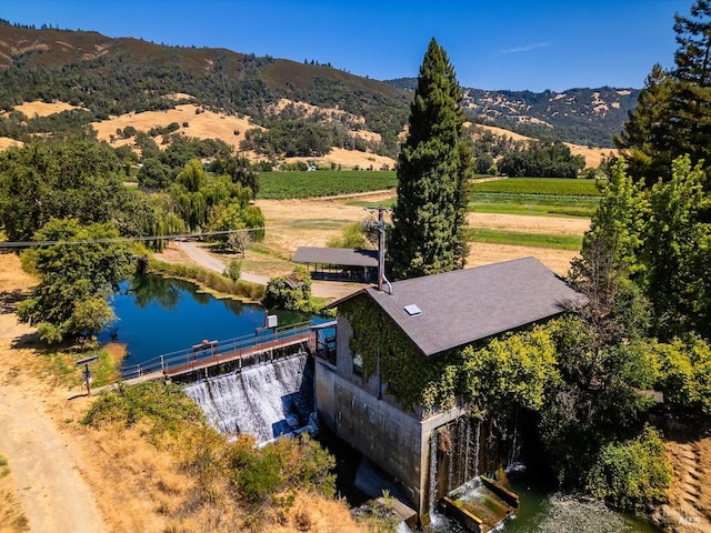 birds eye view of property with a water and mountain view