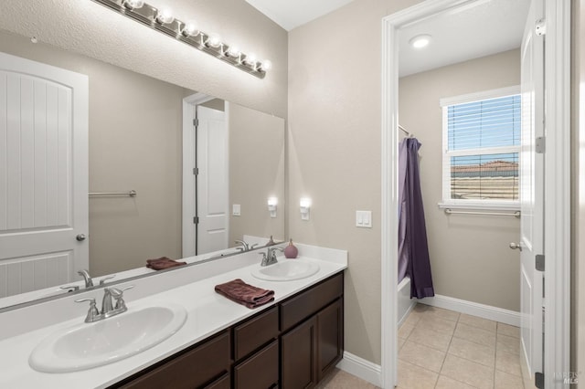 bathroom with double vanity and tile patterned flooring