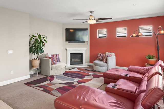 living room featuring ceiling fan, carpet floors, and a wealth of natural light