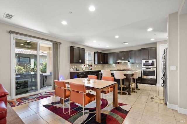 dining space with ceiling fan and light tile patterned floors