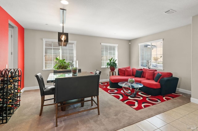 living room with plenty of natural light and light tile patterned floors