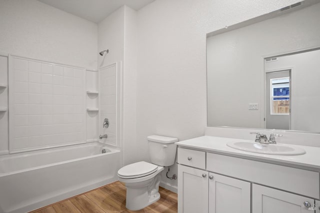 full bathroom featuring toilet, shower / bathtub combination, hardwood / wood-style floors, and vanity