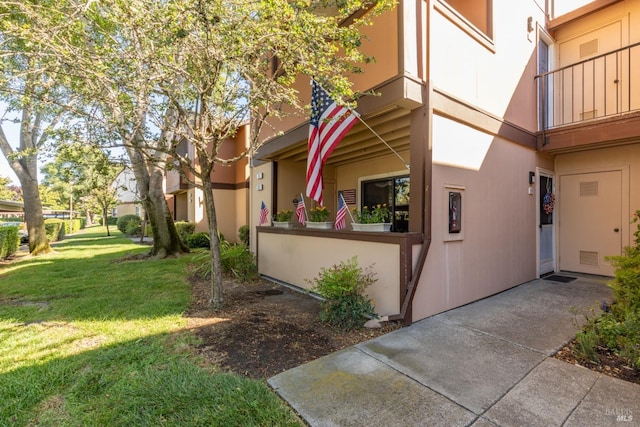 view of side of property with a yard