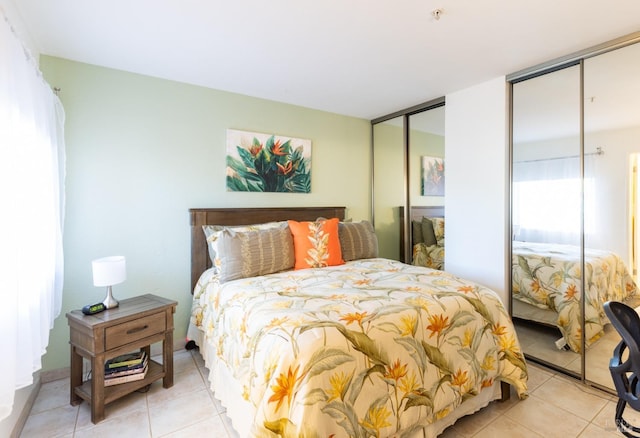 tiled bedroom with multiple closets