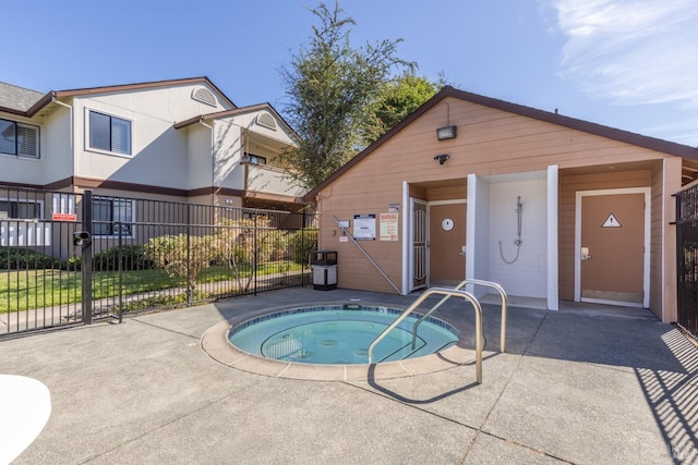 view of swimming pool featuring a hot tub