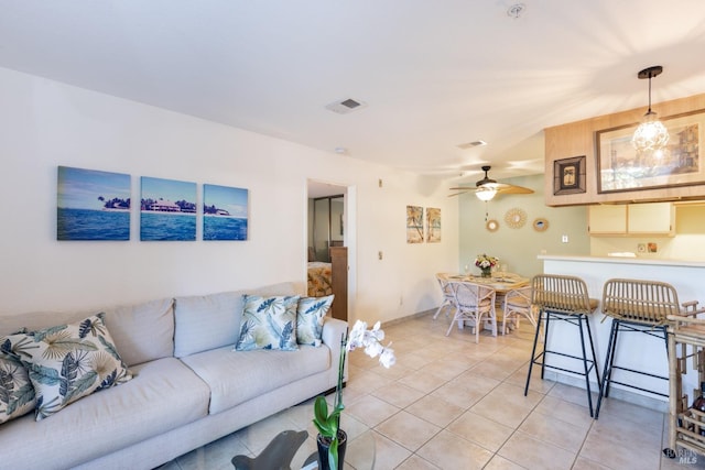 tiled living room featuring ceiling fan