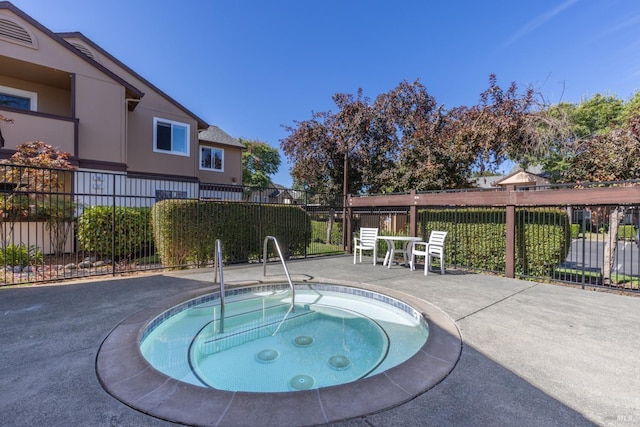 view of pool with a community hot tub