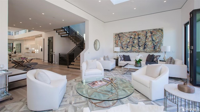 living room with light parquet flooring and a towering ceiling