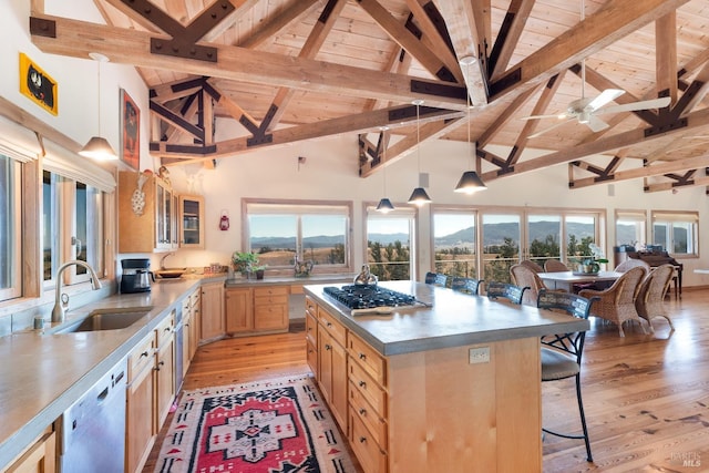 kitchen featuring light wood-type flooring, white dishwasher, sink, high vaulted ceiling, and hanging light fixtures