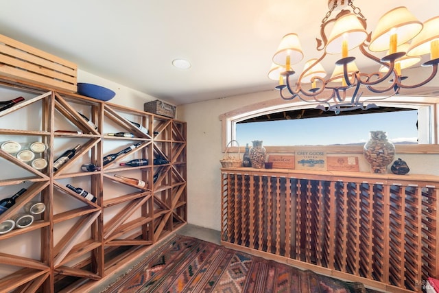 wine area featuring a notable chandelier and hardwood / wood-style flooring