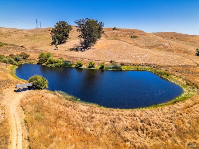 birds eye view of property featuring a water and mountain view