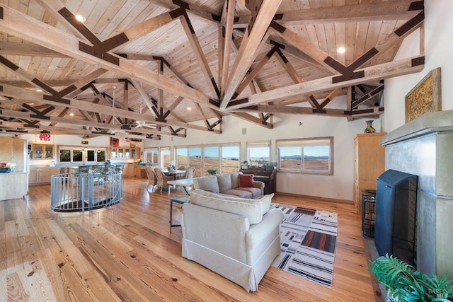 living room with wooden ceiling, beamed ceiling, and light hardwood / wood-style floors