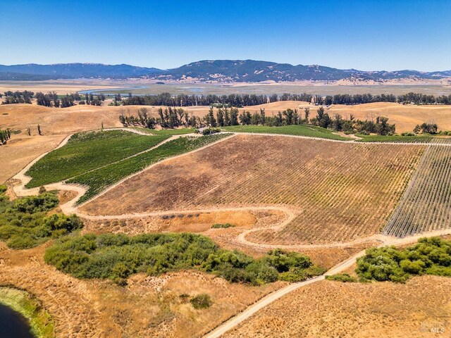 birds eye view of property featuring a mountain view and a rural view