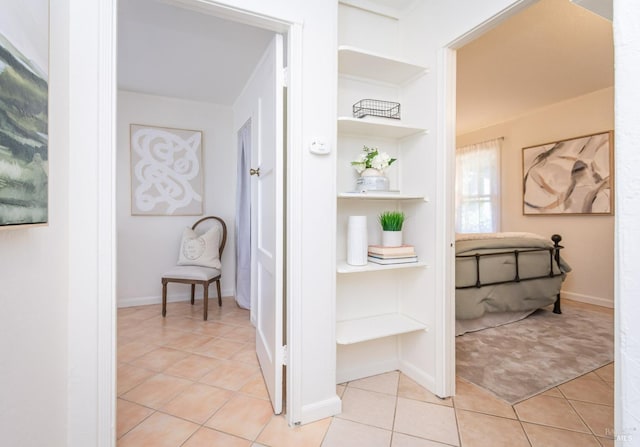 corridor with light tile patterned flooring