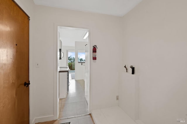 hallway featuring light tile patterned flooring