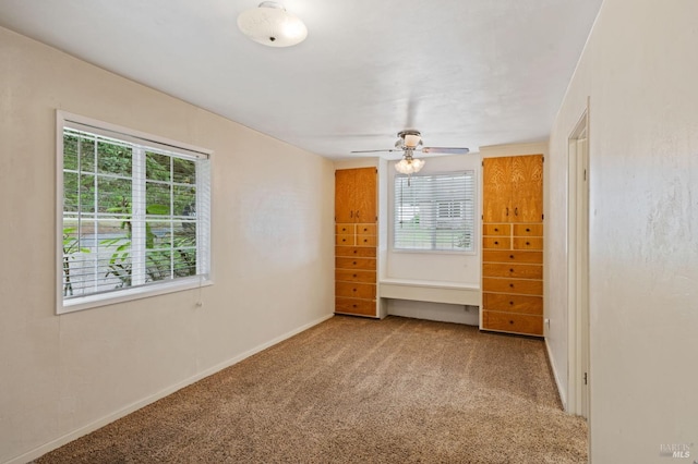 spare room featuring carpet and ceiling fan