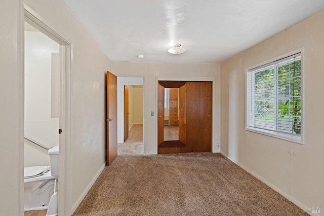 unfurnished bedroom with a closet and carpet floors