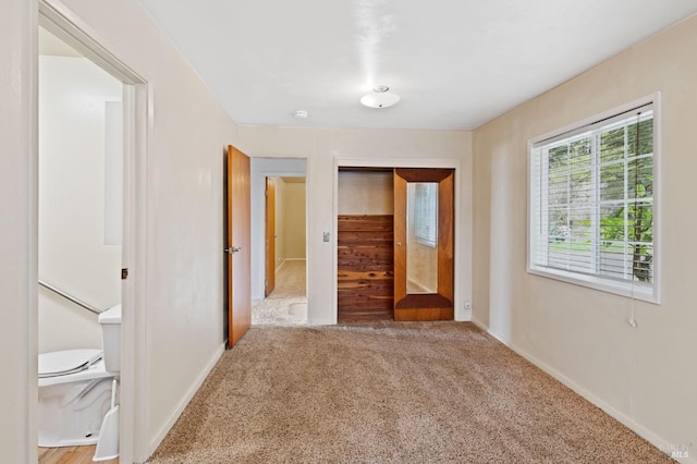 unfurnished bedroom featuring carpet and a closet