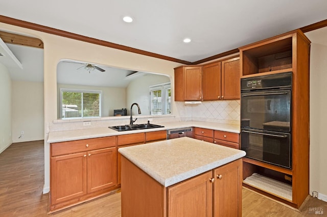 kitchen featuring light hardwood / wood-style flooring, sink, a center island, and double oven