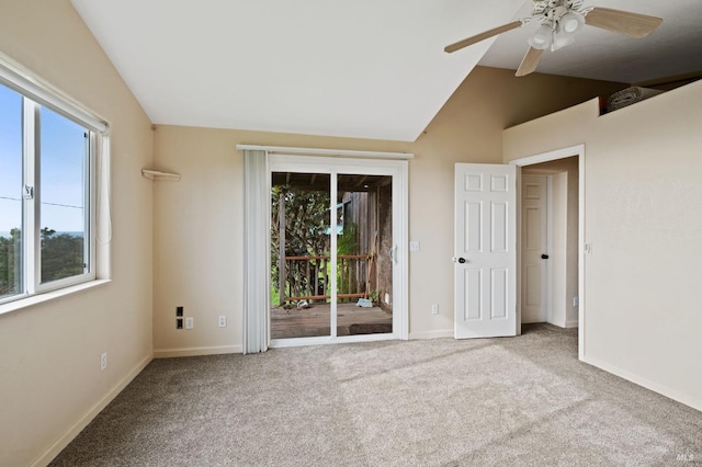 unfurnished bedroom with ceiling fan, light colored carpet, access to outside, and vaulted ceiling