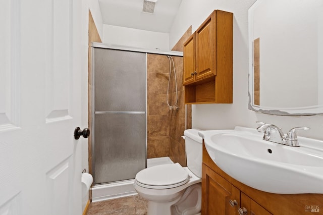 bathroom with tile patterned flooring, vanity, toilet, and walk in shower