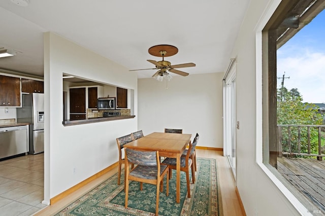 dining room with ceiling fan and light hardwood / wood-style floors